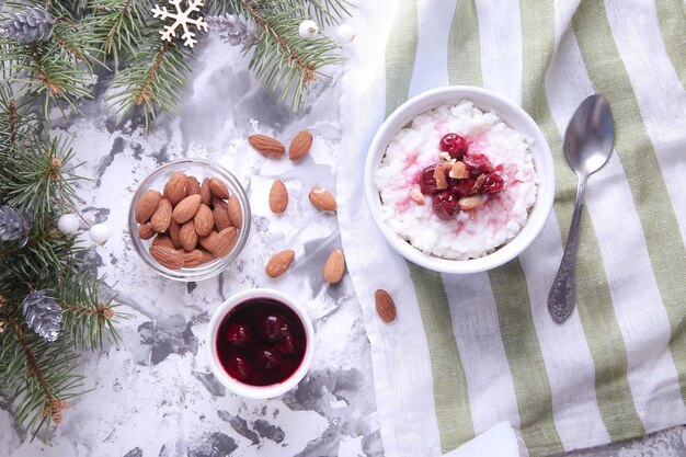 Christmas rice pudding with almonds and cherries on a light background. Risalamande