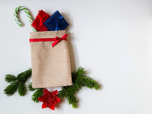 Christmas sack decoration with pinne branches and red flower