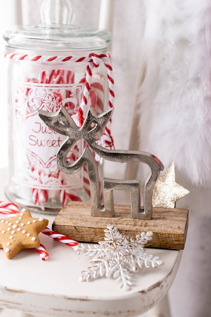 Christmas Santa Claus Hat Hanging On Wood chair, Xmas Concept, Decoration Over Grunge Wooden Background.