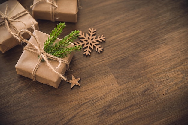 Christmas season Gift boxes with spruce branch on the rustic table