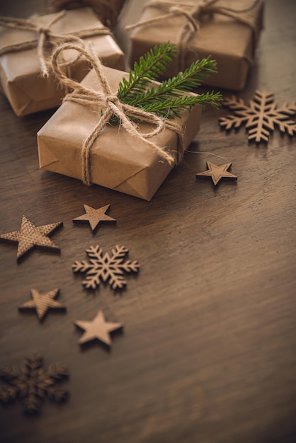 Christmas season Gift boxes with spruce branch on the rustic table