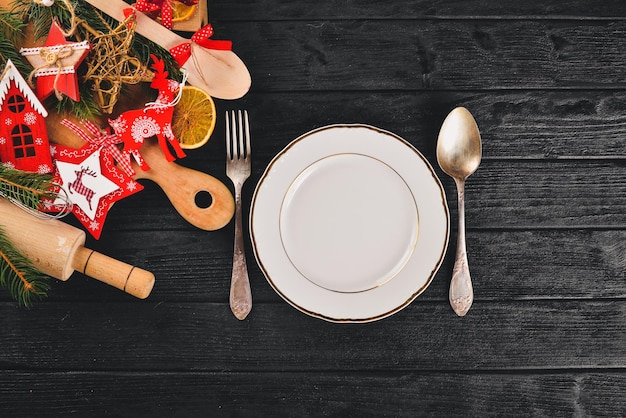 Christmas serving cutlery with plate on a wooden background