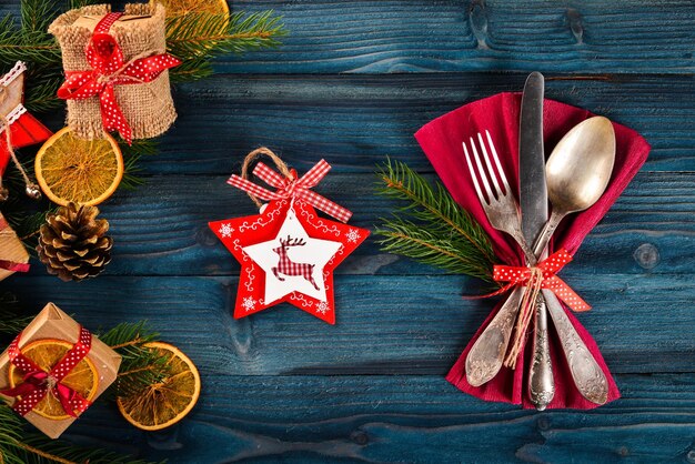 Christmas serving cutlery with plate on a wooden background