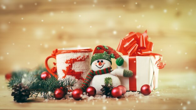 Christmas shopping,a beautiful bowl with Christmas ornaments and a cute snowman on a festive background. the photo has a empty space for your text