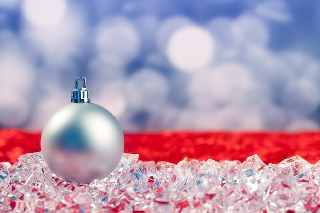 Christmas silver bauble on ice cubes