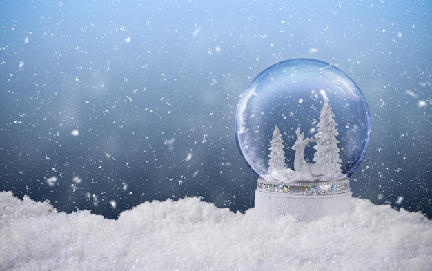 christmas snow globe with reindeer and frozen snowy fir tree inside christmas greeting card with magic snow globe decoration and snow falling christmas background