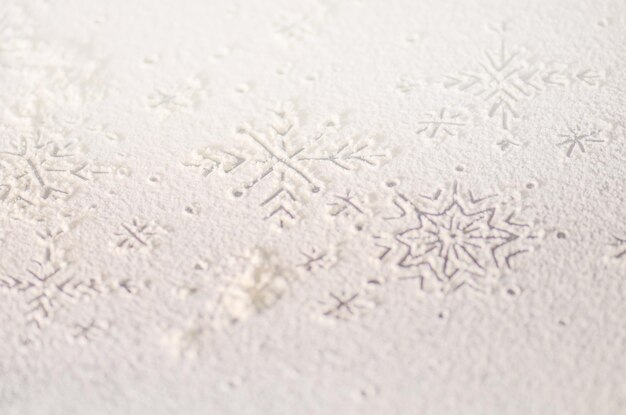 Christmas snowflake made with flour on wooden table