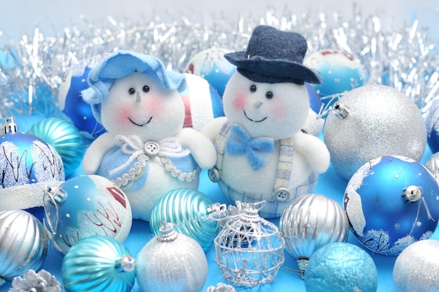 Christmas Snowman and Snow Maiden surrounded by New Year's toys