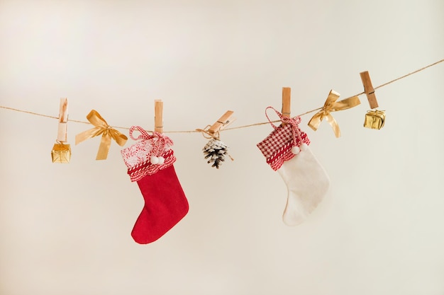 Christmas socks, golden presents and decorations on the rope on white background