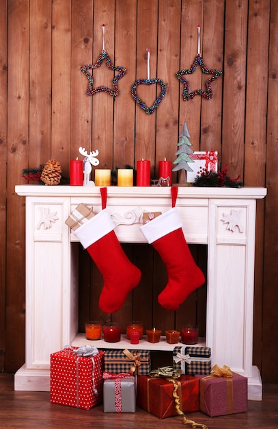 Christmas socks hanging on fireplace in room