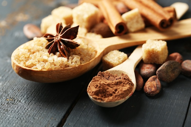 Christmas spices and baking ingredients on color wooden surface