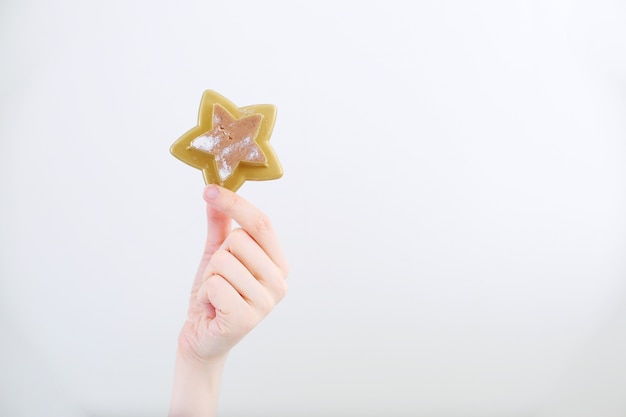 Christmas star cookie in womans hand