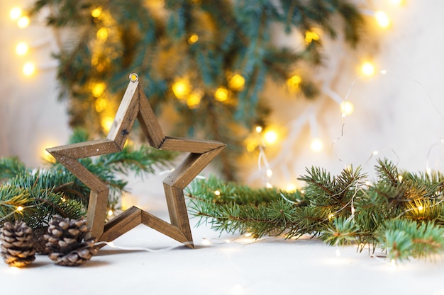 Christmas star, fir branches, new year decorations, notepad on light 