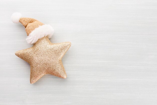 Christmas star and santa hat, decor on paper background.