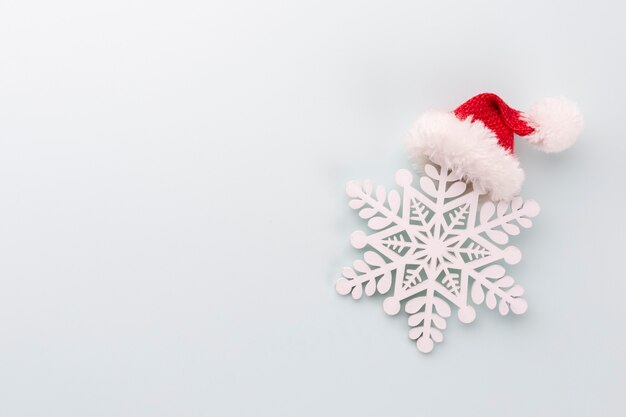 Christmas star and santa hat, decor on pastel blue background.