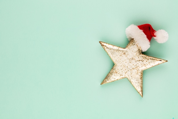 Christmas star with santa hat decoration. Christmas star on blue background.