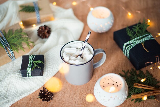 christmas still life with coffee cup gift boxes and candle lights