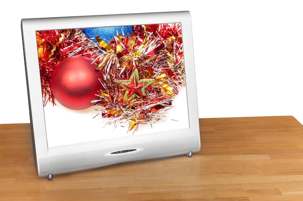 Christmas still life with red ball on screen of TV