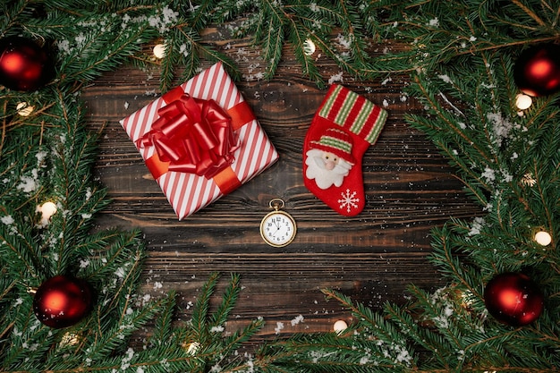 Christmas stockingwatch and gift on a wooden background