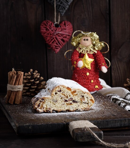 Christmas stollen cake with icing sugar, marzipan and raisins