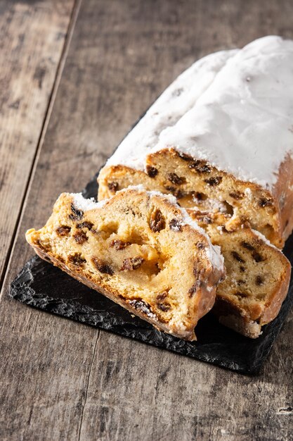 Christmas stollen fruit cake on wooden table