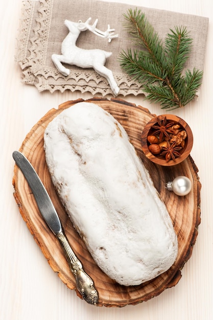 Christmas stollen on light wooden background