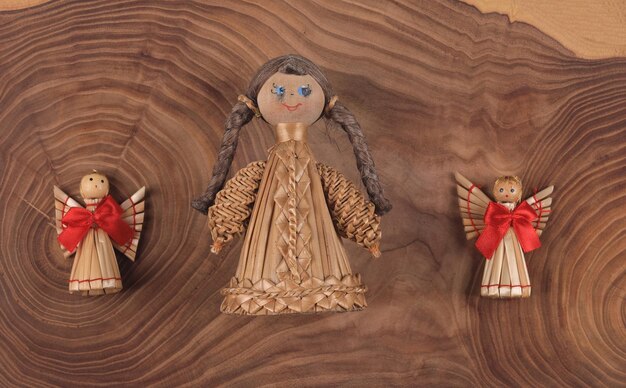 christmas straw toys on wooden background