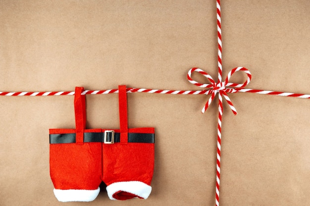 Christmas string or twine tied in a bow on kraft paper backdrop and Santa Claus