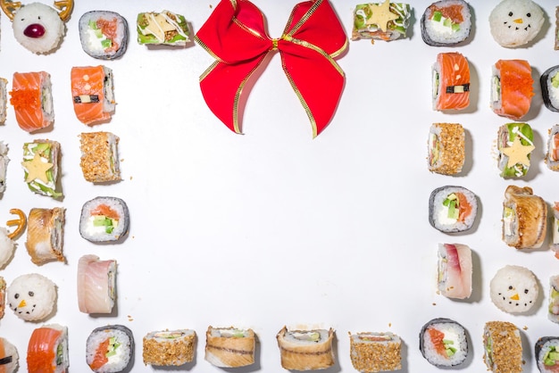 Christmas sushi set with funny decorated rolls like xmas\
symbols ãâãâ¢ãâãâãâãâ santa, deer, snowman, fir tree,\
christmas sushi bar menu, festive delivery mock-up