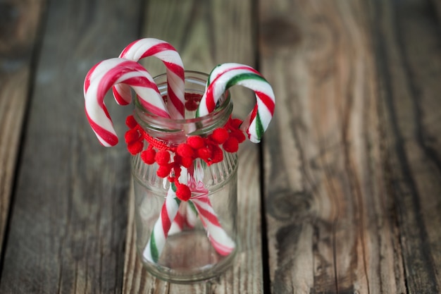 Christmas sweet candys in the glass on the wood background