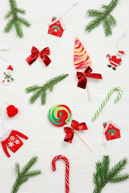christmas sweets assorted top view, green fir branches,  wooden toys