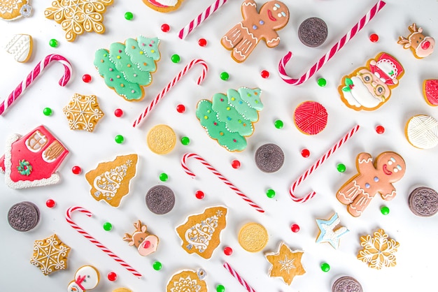 Christmas sweets set. Assorted festive Christmas  sweets, traditional candy and cookie. Flatlay with candy cane candies, gingerbread, sweets, simple pattern top view