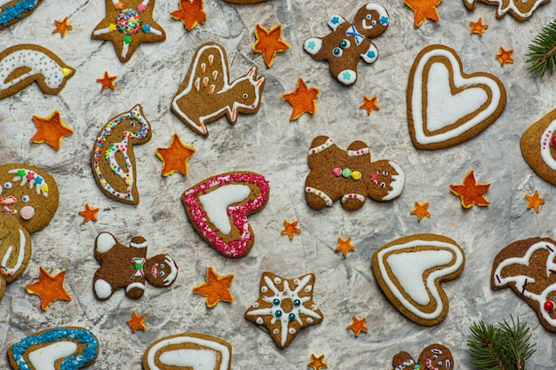 Christmas sweets on wooden table Collection of various gingerbread men