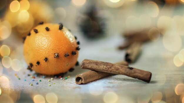 Christmas table background image of cinnamon sticks oranges and\
cookies on wooden background photo w