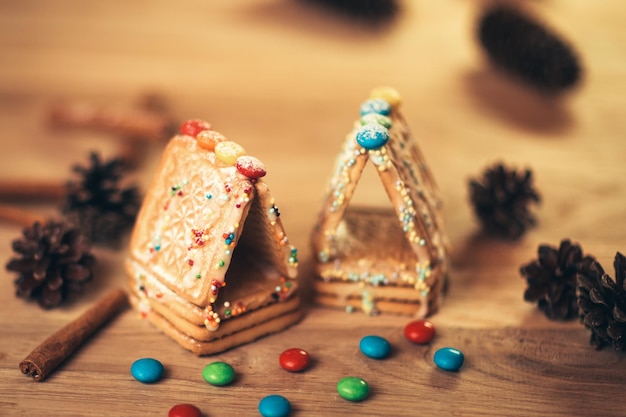 Christmas table cinnamon stickscookies and fir cones on wood