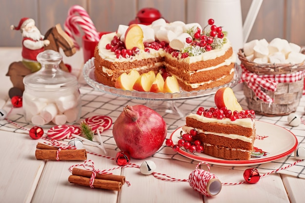 Christmas table decoration, festive fruitcake with sweets on the table