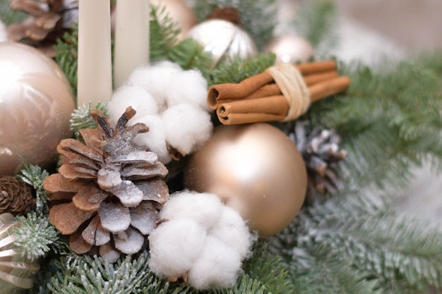 Christmas table decoration with candles, globes and cones. Close up