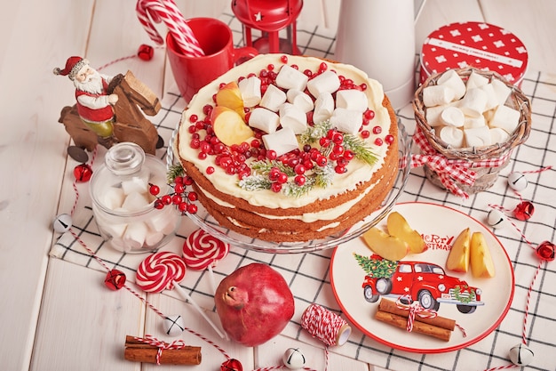 Christmas table decoration with festive fruitcake and sweets on the table