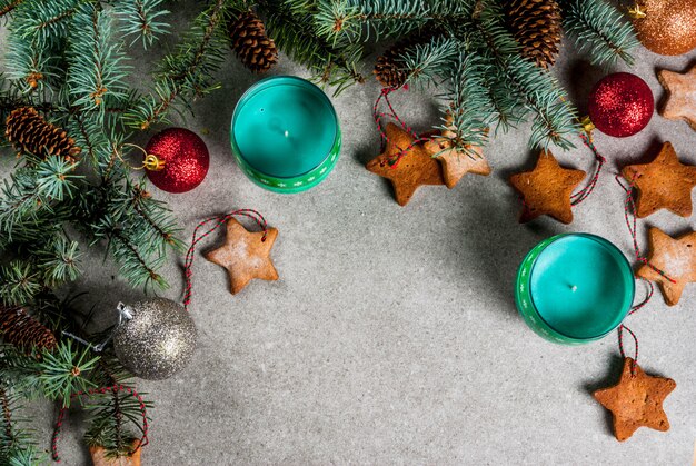 Christmas table,  for greeting card. Christmas decoration, candles, fir tree and gingerbread cookies on grey stone table. Top view, .