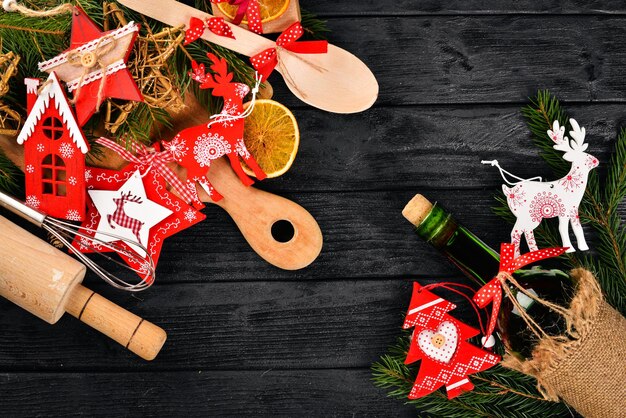 christmas table serving and a bottle of wine new year christmas tree and christmas tree decorations on a wooden background free space for text