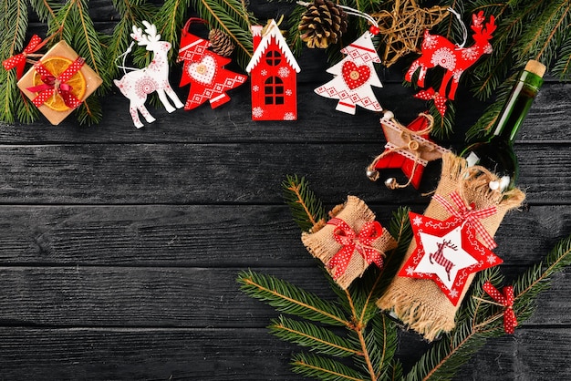 Christmas table serving and a bottle of wine New Year Christmas tree and Christmas tree decorations On a wooden background Free space for text