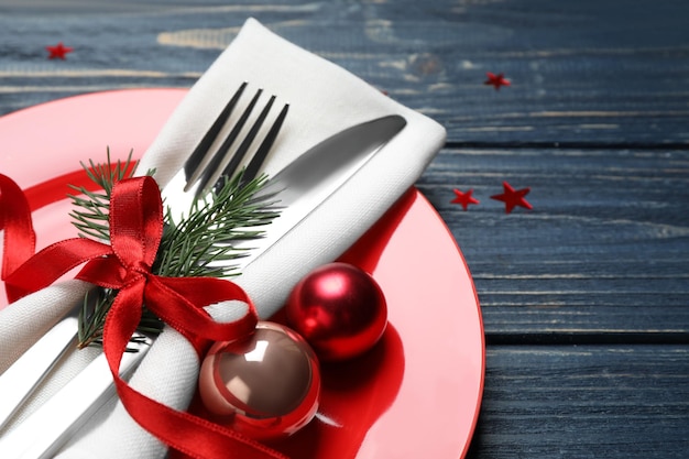 Christmas table setting on blue wooden background closeup