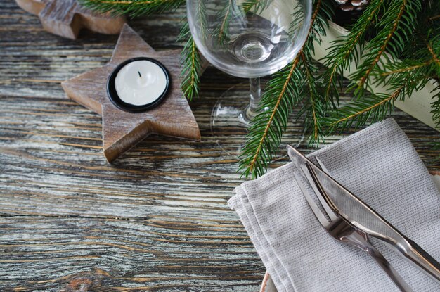 Christmas table setting. Festive composition with candles and fir branches