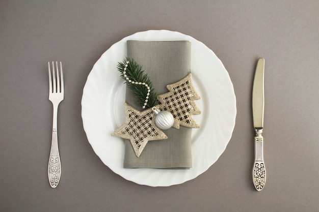 Christmas table setting on the gray background. Top view. Copy space.