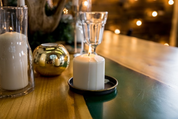 Christmas table setting in rustic style with candles plates glasses and eco decors .festive table