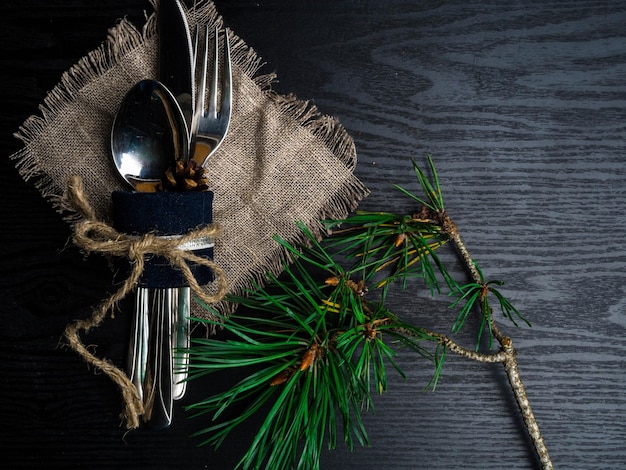 Christmas table setting in silver tone on wooden table