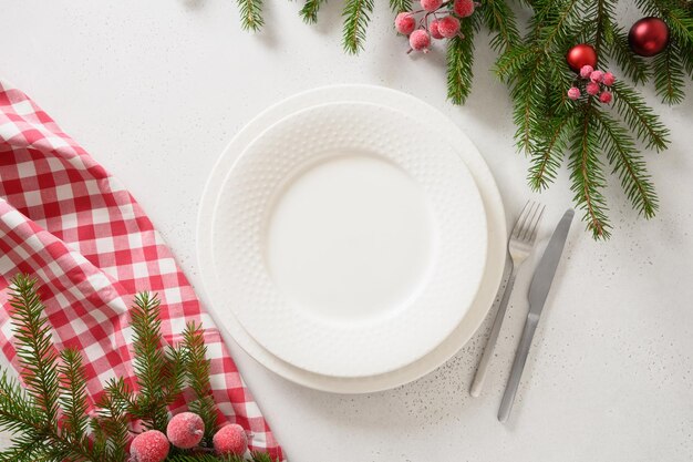 Christmas table setting with elegant red decorations on white table View from above