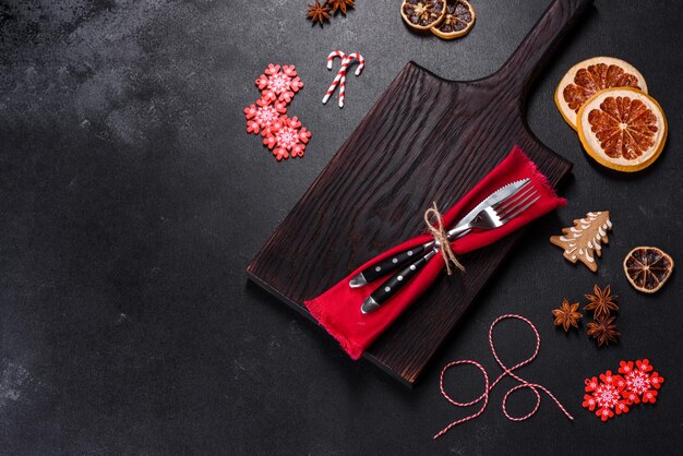 Christmas table setting with empty black ceramic plate fir tree and black accessories