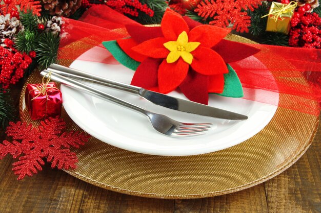 Christmas table setting with festive decorations close up