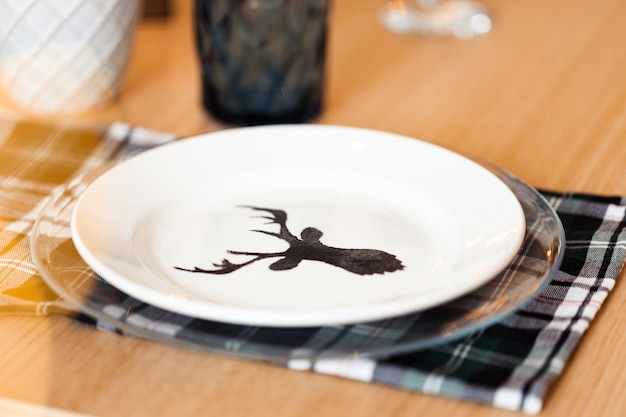 Christmas table setting with plate with deer silhouette